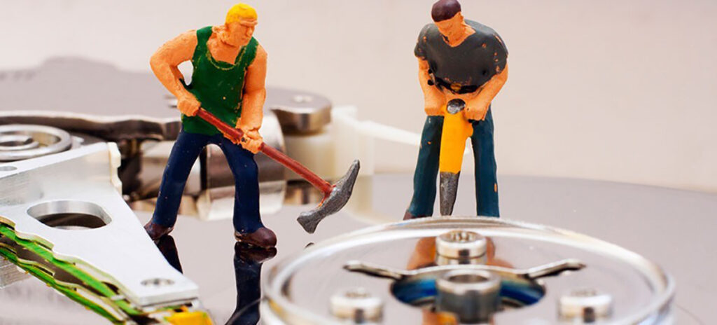 A photo of construction worker figurines deconstructing objects