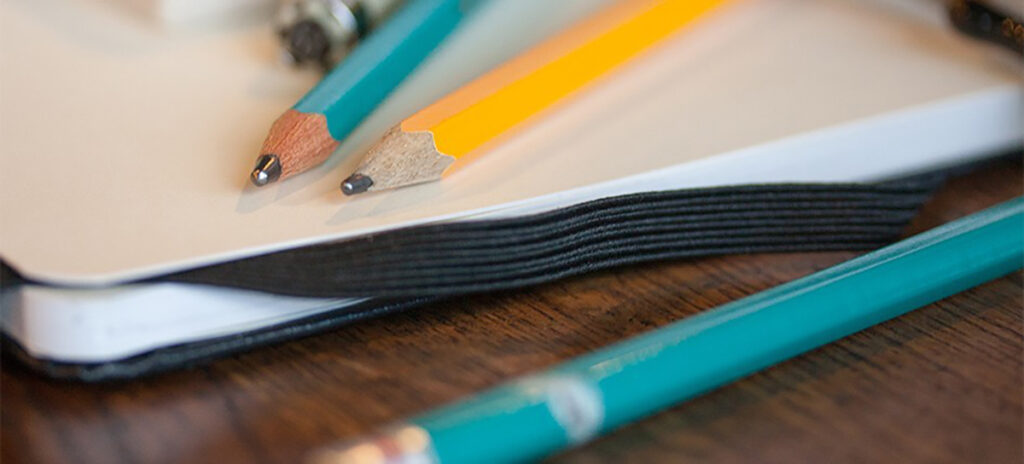 Pencils and a notebook on a table