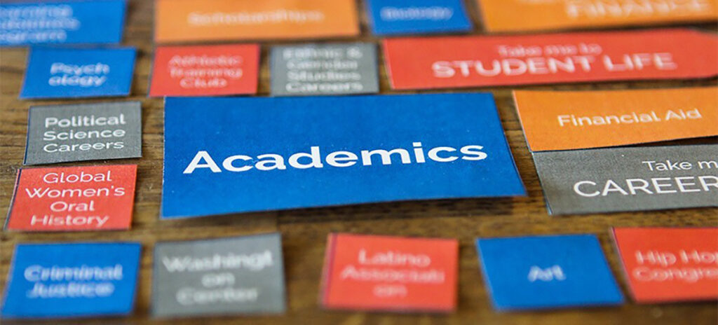 Cutouts labeled with academic subjects arranged on a table