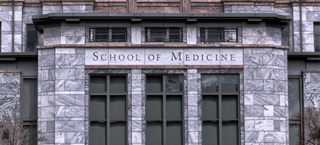 Stone building facade with "School of Medicine" engraved over windows