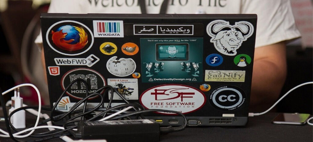 A laptop decorated with multiple stickers