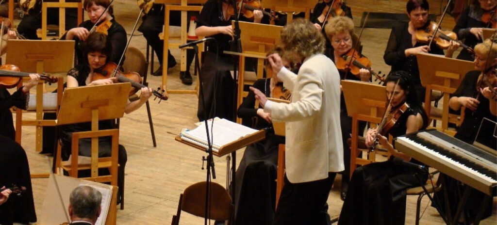 A conductor leads a symphony orchestra