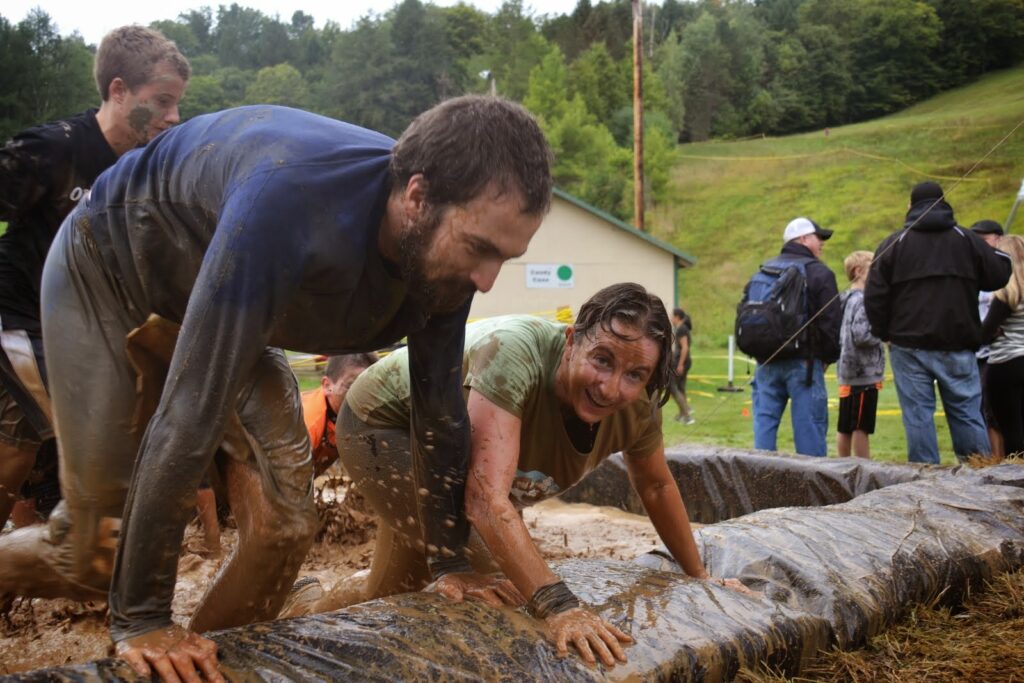 Andy and his wife participating in a mud run