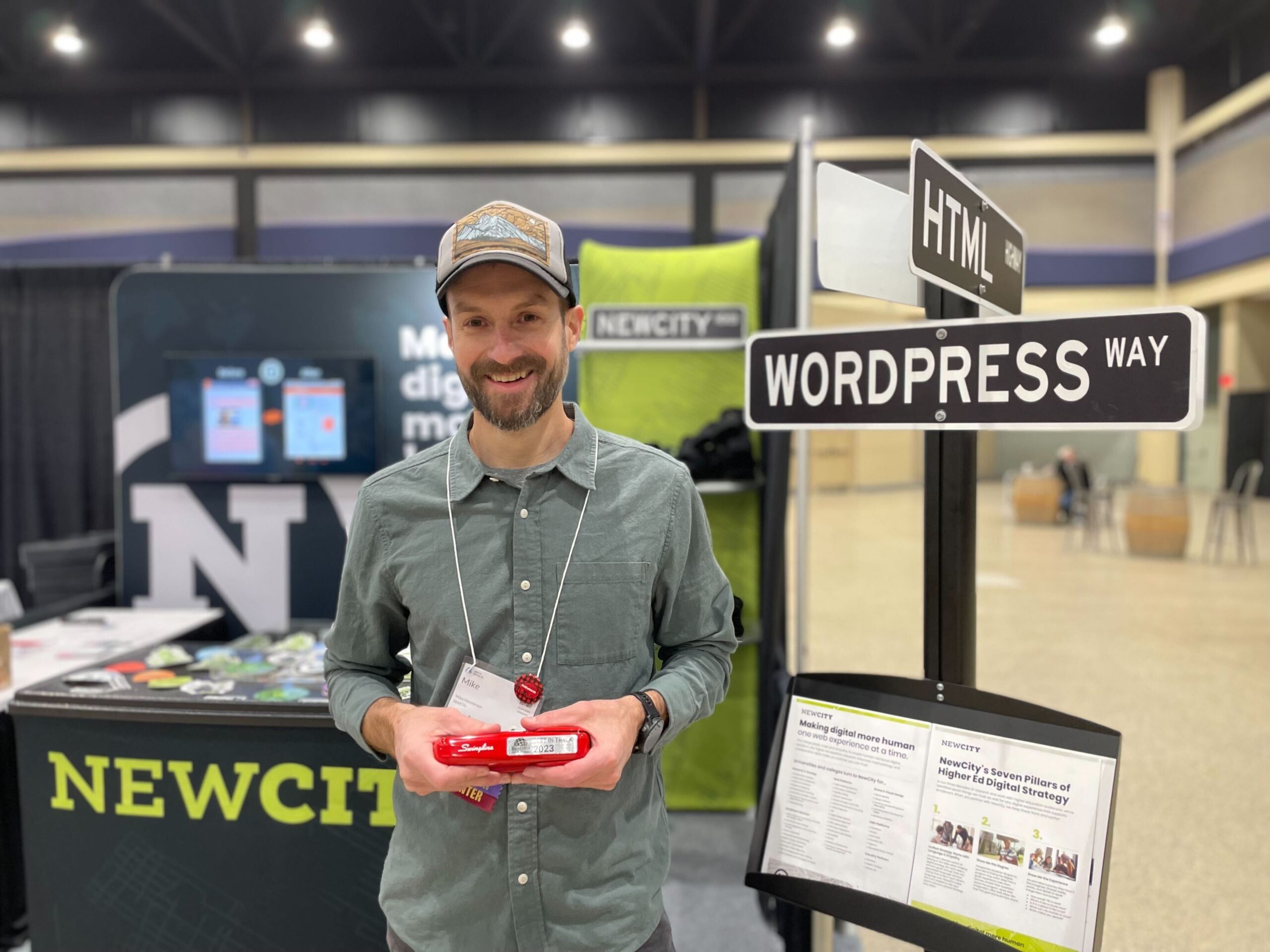 Mike standing in front of the NewCity table near WordPress Way