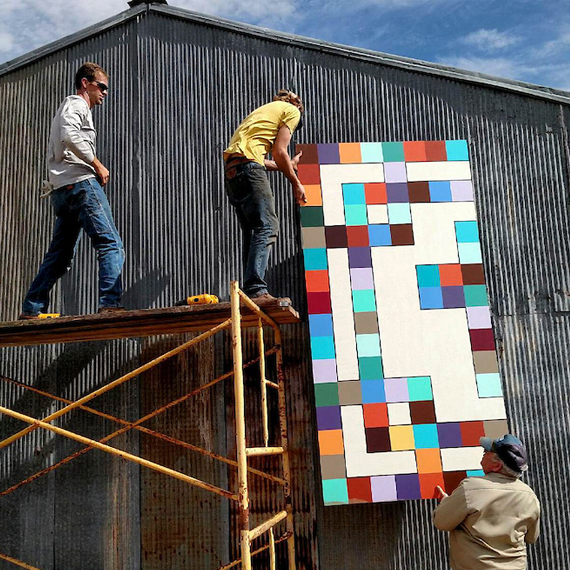 Extension workers hanging outdoor art