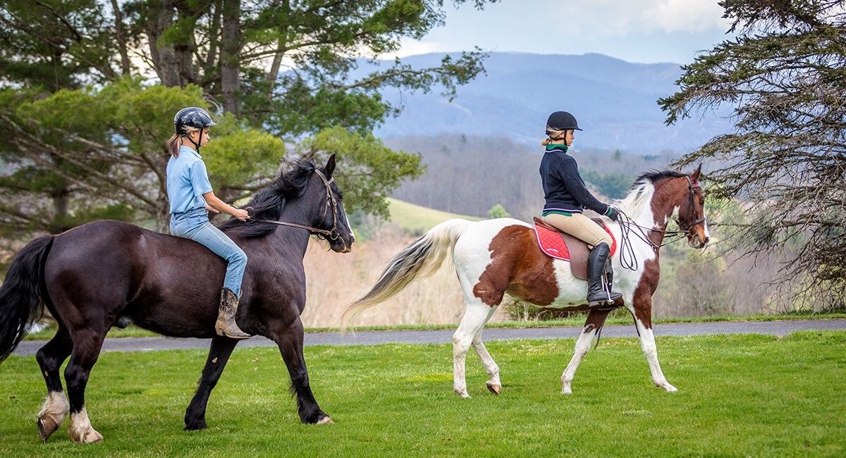 Two female students ride horses