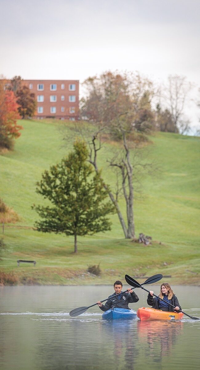 Two students kayak on the Oak Hill campus