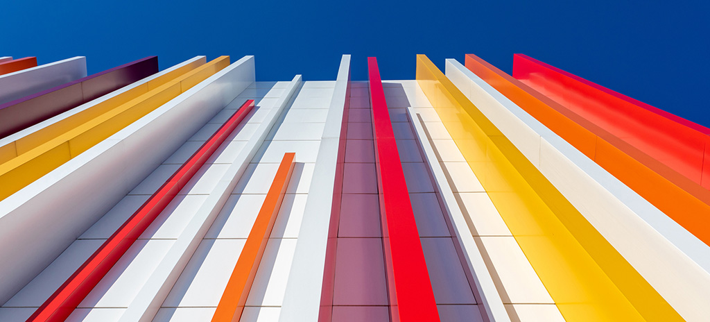 multi-colored plastic pillars along a wall, looking up