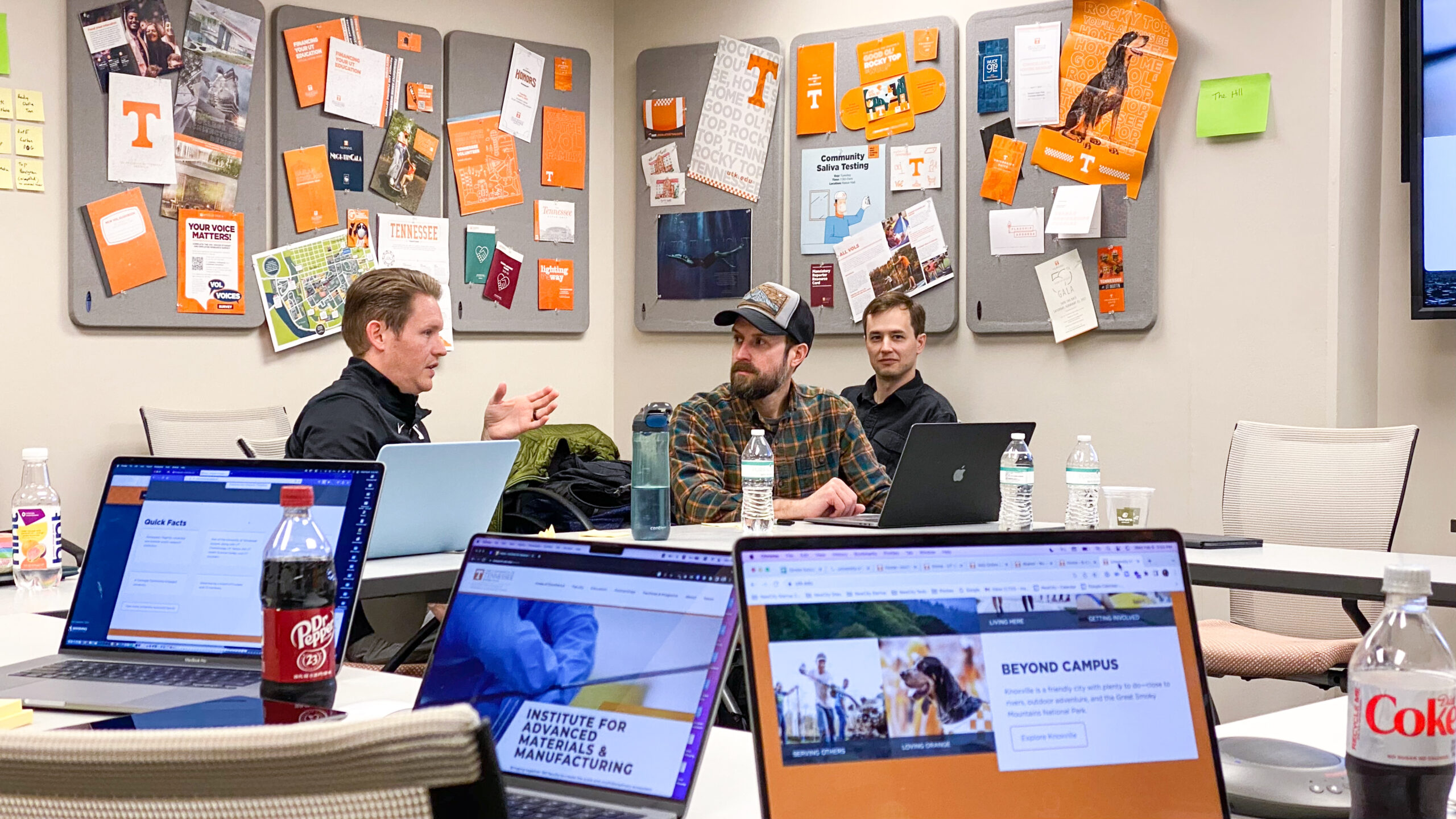 Three men sit in a conference room at the University of Tennessee Knoxville with laptops working on website mapping